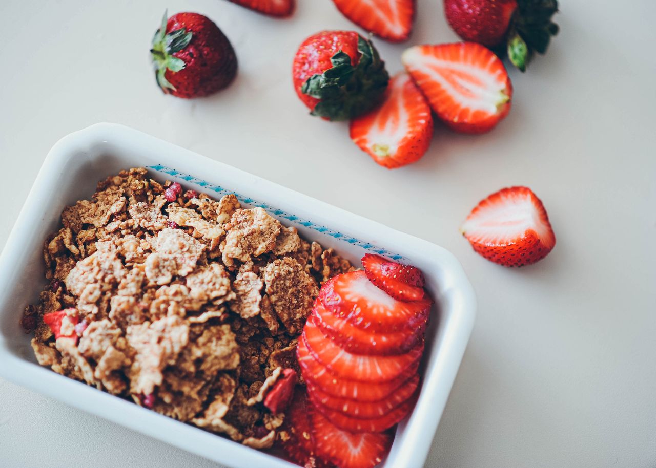 Close-up view of strawberries and cereal for a nutritious breakfast option.